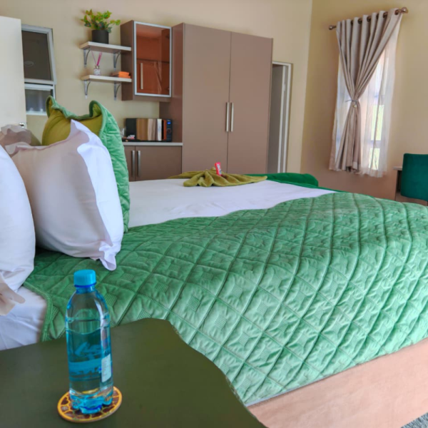 Lilitha accommodation bedroom with green bedding